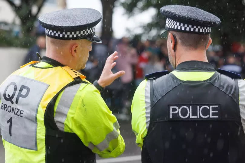 Two police officers looking away from the camera