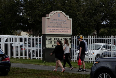 People walk past the David Posnack Jewish Day School after the second bomb threat in a month was reported in Davie, Florida, U.S. March 7, 2017. REUTERS/Andrew Innerarity