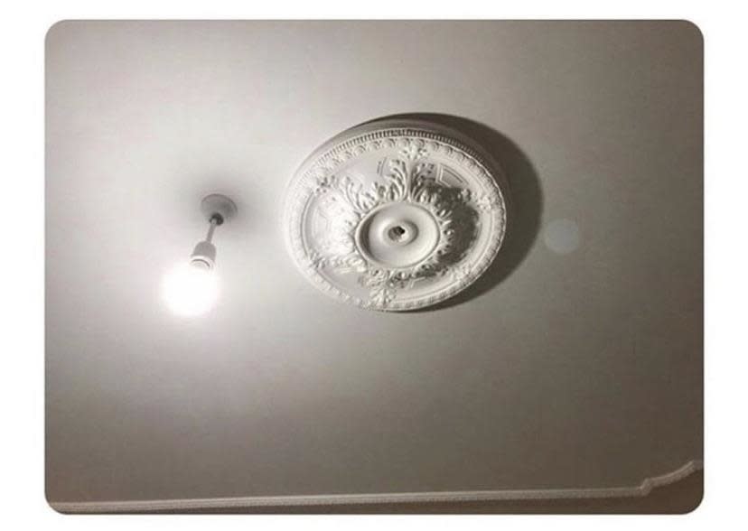 A light installed about six inches away from the light's decorative fixture