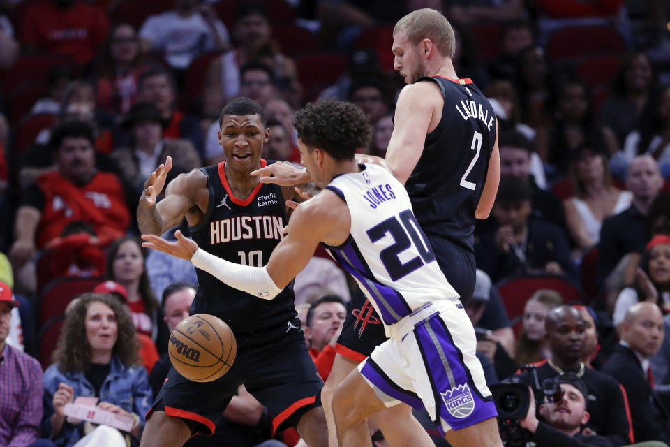 Houston Rockets forward Jabari Smith Jr. (10) and center Jock Landale (2) and Sacramento Kings guard Colby Jones (20) try to get possession of the ball during the first half of an NBA basketball game Saturday, Nov. 4, 2023, in Houston. (AP Photo/Michael Wyke)