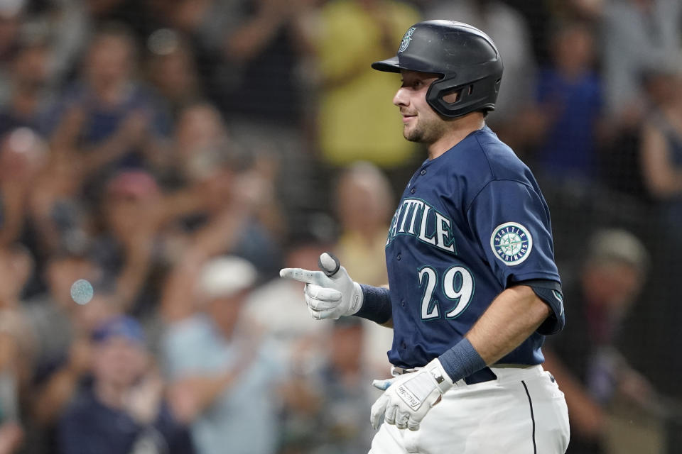 Seattle Mariners' Cal Raleigh reacts after crossing the plate after he hit a solo home run against the Texas Rangers during the seventh inning of a baseball game, Tuesday, July 26, 2022, in Seattle. (AP Photo/Ted S. Warren)