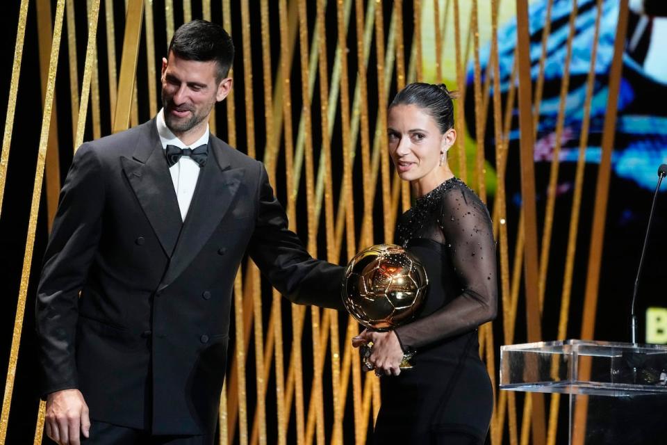 Spain's Aitana Bonmati, right, receives the Women's Ballon d'Or award from Serbian tennis player Novak Djokovic during the 67th Ballon d'Or award ceremony in Paris on Oct. 30. (Associated Press - image credit)