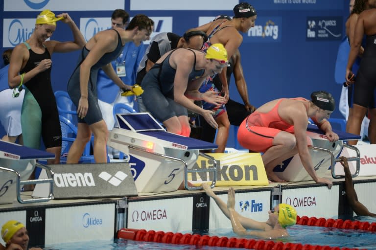 Cate Campbell, Bronte Campbell, Emma McKeon and Emily Seebohm celebrate as they win the gold medal in the final of the women's 4x100m freestyle relay swimming event at the 2015 FINA World Championships in Kazan on August 2, 2015