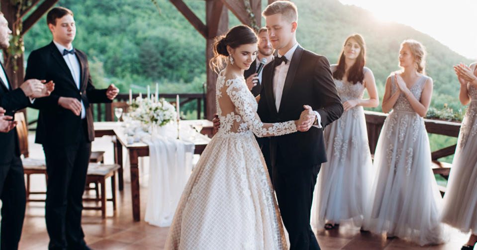 Bride and Groom dance while groomsmen and bridesmaids surround them.