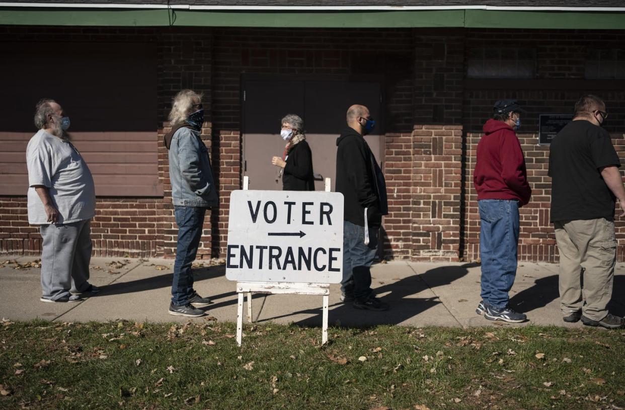 <span class="caption">People have information on how they'll vote, but also about how others in their community may vote.</span> <span class="attribution"><a class="link " href="https://newsroom.ap.org/detail/USElection2020WisconsinMisinformation/52a5b75dca5245b48ebc25f296547302/photo" rel="nofollow noopener" target="_blank" data-ylk="slk:AP Photo/Wong Maye-E;elm:context_link;itc:0;sec:content-canvas">AP Photo/Wong Maye-E</a></span>