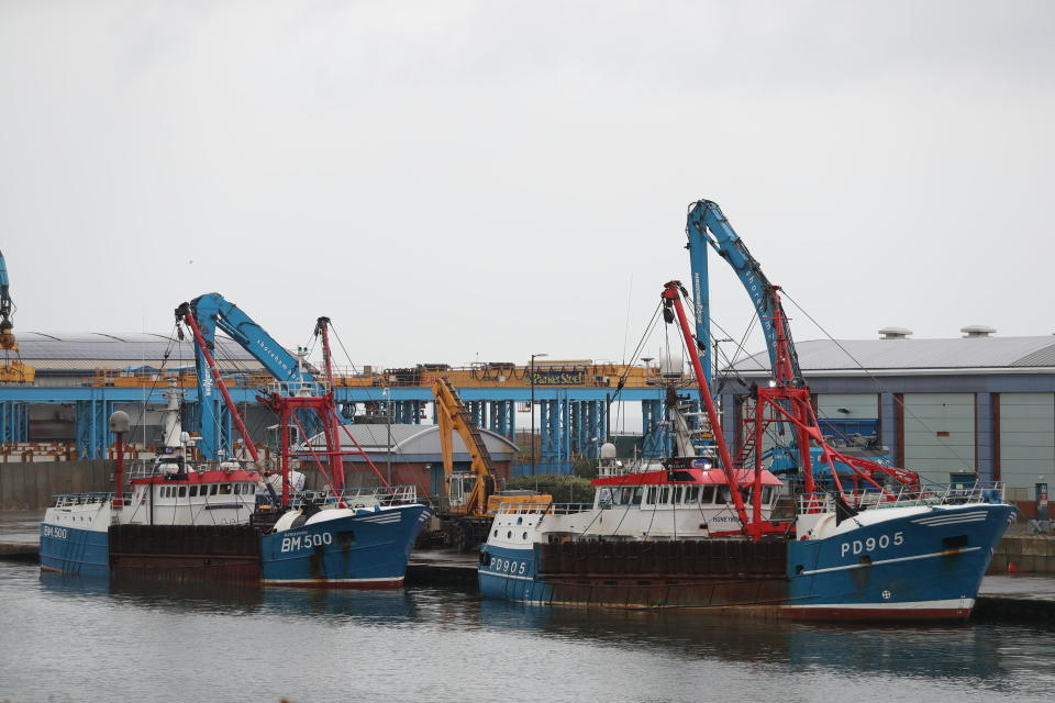 The Honeybourne 3, right, a Scottish scallop dredger, in dock at Shoreham, south England, Wednesday Aug. 29, 2018, following clashes with French fishermen in the early hours of Tuesday morning off France's northern coast. French maritime authorities are appealing for calm after fishermen from rival French and British fleets banged their boats in ill-tempered skirmishes over access to the scallop-rich waters off France's northern coast. (Andrew Matthews/PA via AP)