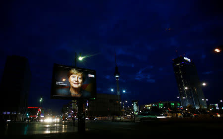 An election campaign poster for the upcoming general elections of the Christian Democratic Union party (CDU) with a headshot of German Chancellor Angela Merkel is displayed at Alexanderplatz square in Berlin, Germany, September 21, 2017. REUTERS/Hannibal Hanschke