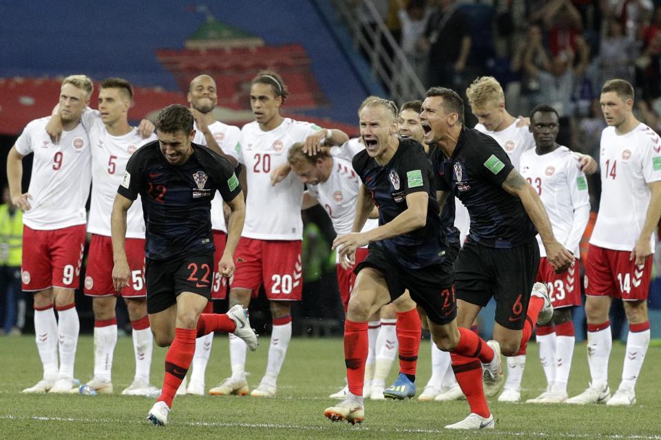 <p>Croatian players celebrate when teammate Ivan Rakitic scored the winning penalty as the Danish team look on </p>