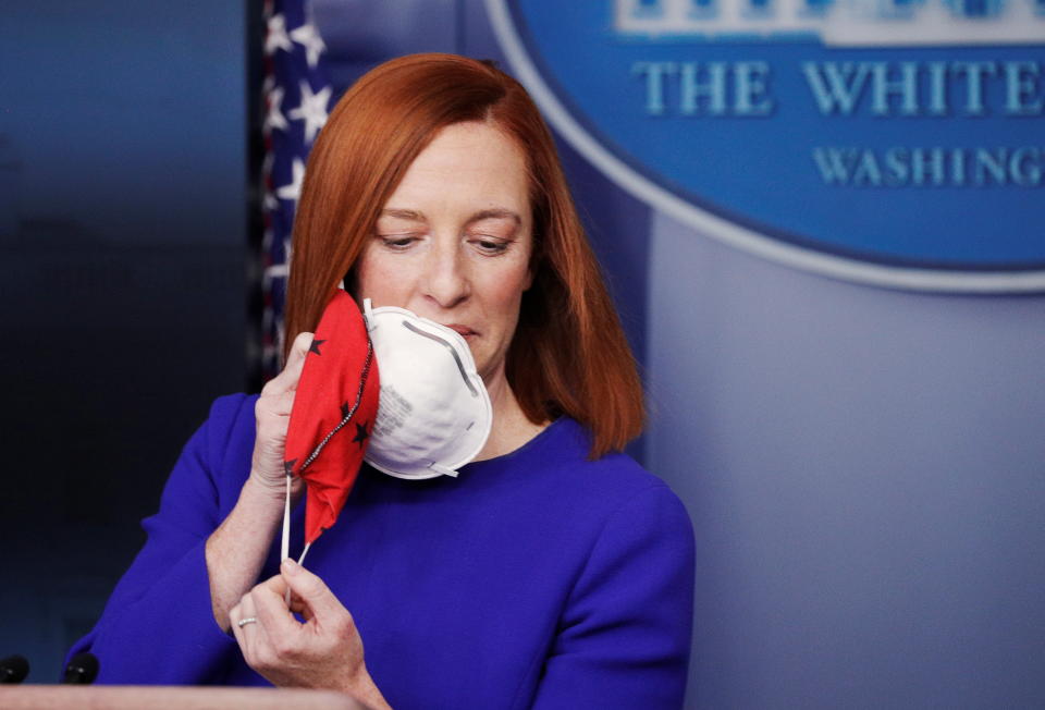 White House Press Secretary Jen Psaki removes her face mask before speaking in the James S Brady Press Briefing Room at the White House, after the inauguration of Joe Biden as the 46th President of the United States, U.S., January 20, 2021. REUTERS/Tom Brenner