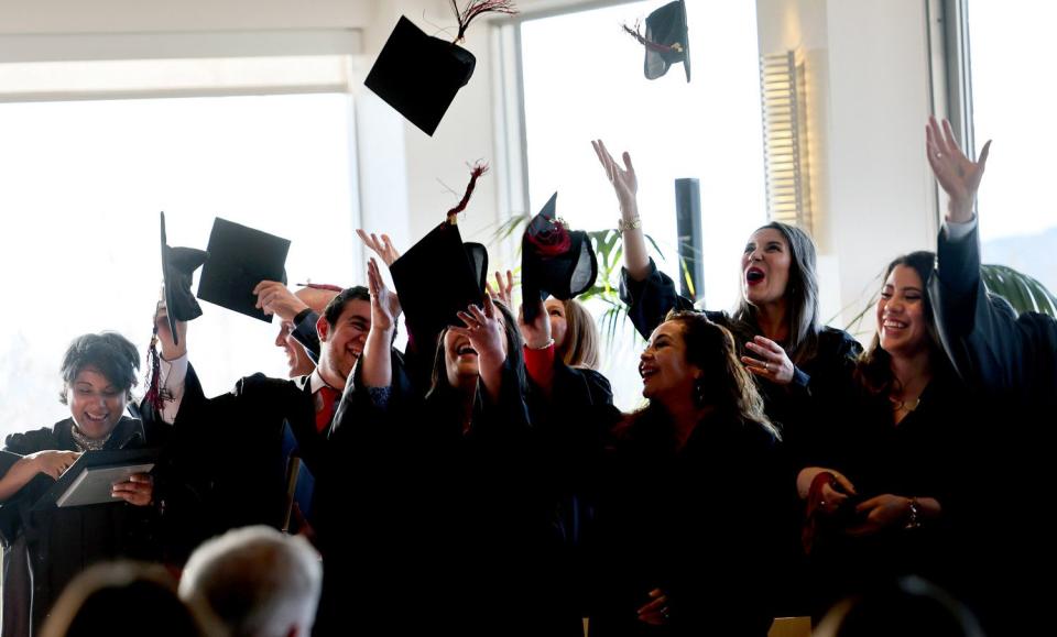 Students toss their caps after receiving their certificates as the University of Utah’s English Language Institute holds the 43rd Cohort Graduation Ceremony at the Crimson View, on campus in Salt Lake City on April 19.