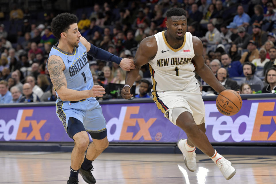 New Orleans Pelicans forward Zion Williamson, right, handles the ball against Memphis Grizzlies guard Scotty Pippen Jr., left, in the first half of an NBA basketball game Monday, Feb. 12, 2024, in Memphis, Tenn. (AP Photo/Brandon Dill)
