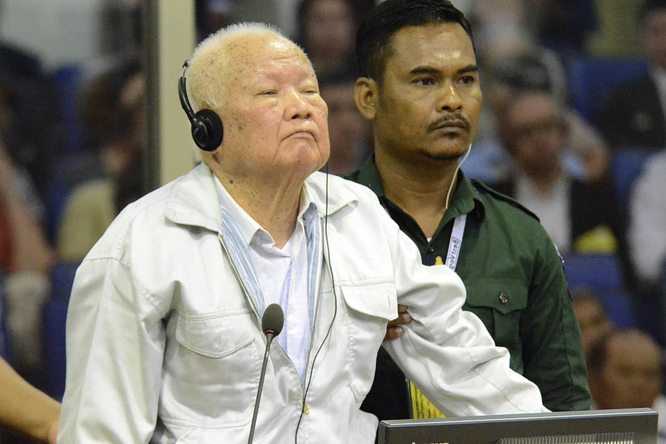 FILE - In this photo released by the Extraordinary Chambers in the Courts of Cambodia, Khieu Samphan, left, former Khmer Rouge head of state, appears in court during the U.N.-backed war crimes tribunal in Phnom Penh, Cambodia, Friday, Nov. 16, 2018. (Nhet Sok Heng/Extraordinary Chambers in the Courts of Cambodia via AP, File)