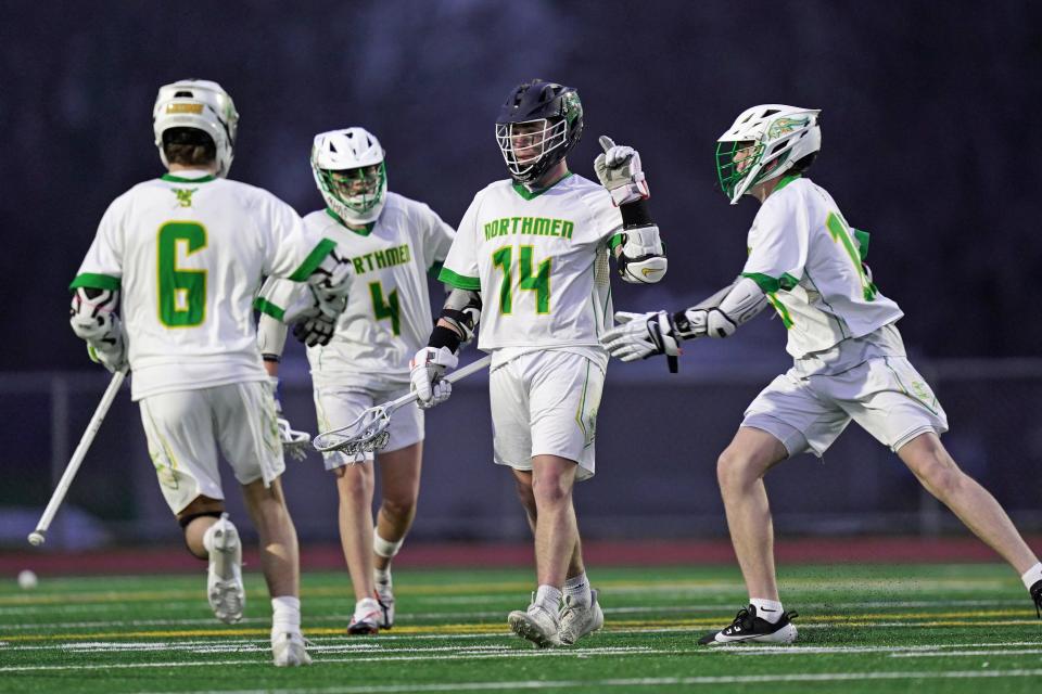North Smithfield's Nathan Gravel celebrates with teammates after scoring the Northmen's first goal of the game in the third quarter in Wednesday's crazy five-overtime win over Lincoln.