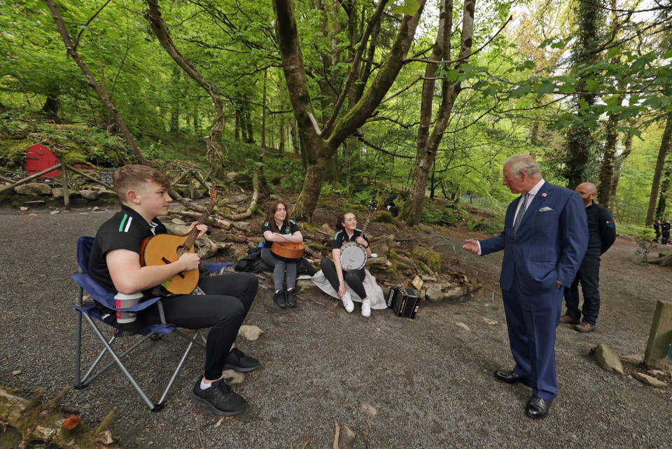 <p>The Prince of Wales talks with (left to right) Brendan O'Sullivan playing bouzouki, Ciara Grant playing bodhran, and Claire Gasey playing banjo, from the the Ring of Gullion Traditional Arts Partnership, during a visit to Slieve Gullion Forest Park in Meigh, Newry. Picture date: Tuesday May 18, 2021.</p>
