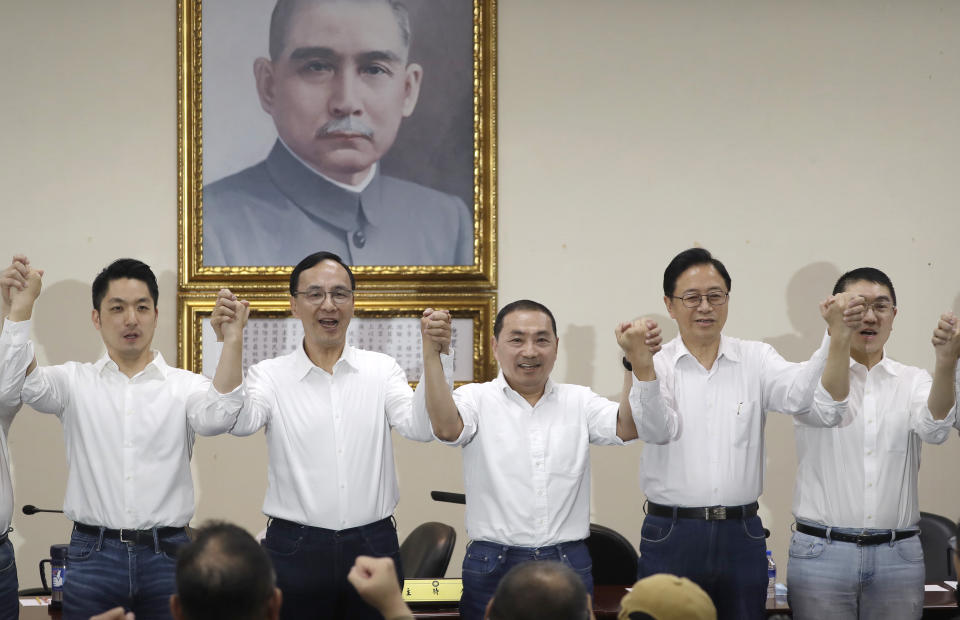 New Taipei City Mayor Hou You-yi, center, cheers with party members as he is nominated as presidential candidate during a press conference in Taipei, Taiwan, Wednesday, May 17, 2023. Taiwan's Nationalist Party has selected the current New Taipei City mayor Hou, as their candidate in the upcoming presidential elections next year. (AP Photo/Chiang Ying-ying)