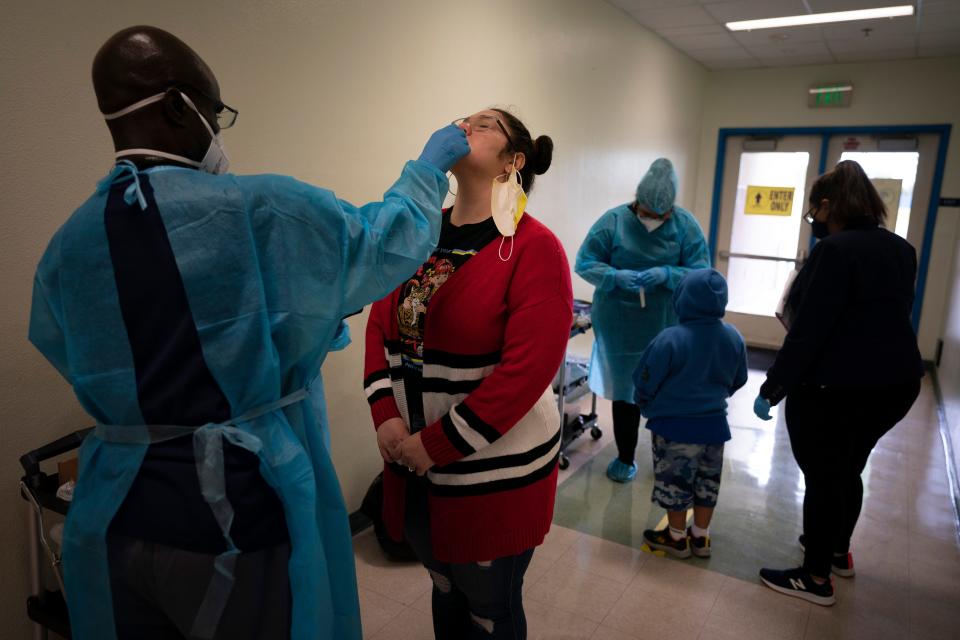 School employee Amanda Anguiano gets tested for COVID-19 on the first day of in-person learning at Maurice Sendak Elementary School in Los Angeles, Tuesday, April 13, 2021.