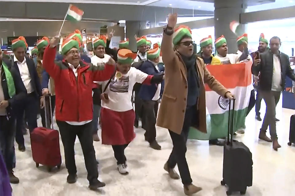 In this image made from video, Indian expats wearing traditional dress walk through Sydney Airport, in Sydney, Australia, Tuesday, May 23, 2023. Hundreds of Indian Australians have arrived on a charter flight from Melbourne to Sydney to attend an community event for visiting Prime Minister Narendra Modi. (Australian Broadcasting Corp. via AP)