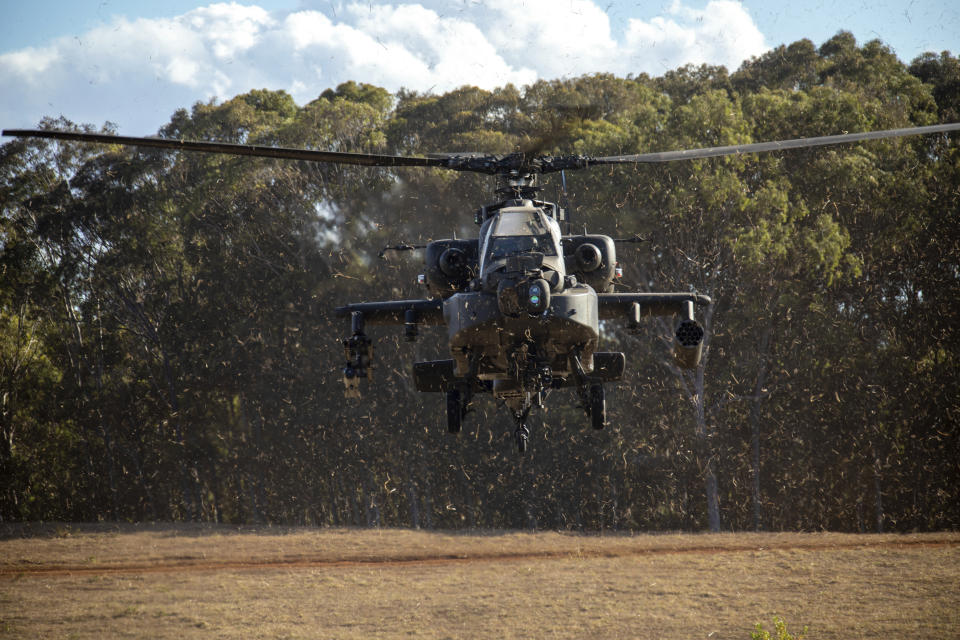 In this photo released by the U.S. Army, U.S. Army aircraft assigned to the 25th Combat Aviation Brigade, 25th Infantry Division, fly into Kahuku Training Area, Hawaii, Nov. 2, 2023, during JPMRC. In this photo released by the U.S. Army, gunners assigned to 1163 Battery, 16th Field Regiment, Royal Regiment of New Zealand Artillery, provide comprehensive fires support to 3rd Infantry Brigade Combat Team, 25th Infantry Division, on Area X-Ray, Schofield Barracks, Hawaii, Nov. 2, 2023. In the largest-scale training held in Hawaii so far, more than 5,000 troops from the 25th Infantry Division, along with units from New Zealand, Indonesia, Thailand and Britain and supported by the U.S. Air Force, have been practicing fighting in an island jungle environment against an advanced enemy force, with exercises including paratrooper drops, a long range air assault, and re-supply by air and sea.(Sgt. Richard Mohr/U.S. Army via AP)