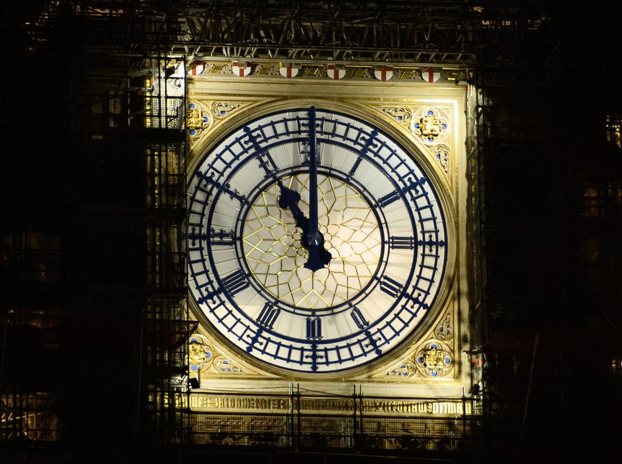 <p> The clock face of Elizabeth Tower, commonly known as Big Ben, is seen at the stroke of 11pm on December 31, 2020</p> (Getty Images)