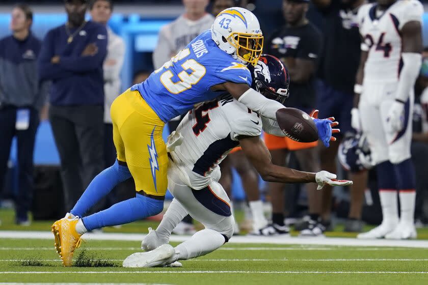 Los Angeles Chargers cornerback Michael Davis (43) breaks up a pass intended for Denver Broncos wide receiver Courtland Sutton (14) during the second half of an NFL football game, Monday, Oct. 17, 2022, in Inglewood, Calif. (AP Photo/Marcio Jose Sanchez)