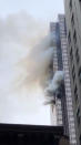 <p>Smoke rises up from Trump Tower in New York, April 7, 2018 in this picture obtained from social media. (Photo: Twitter@brightbazaar/via Reuters) </p>