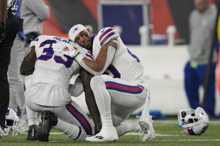 Buffalo Bills&#39; Siran Neal (33) and Nyheim Hines react after teammate Damar Hamlin was injured during the first half of an NFL football game against the Cincinnati Bengals, Monday, Jan. 2, 2023, in Cincinnati. (AP Photo/Jeff Dean)