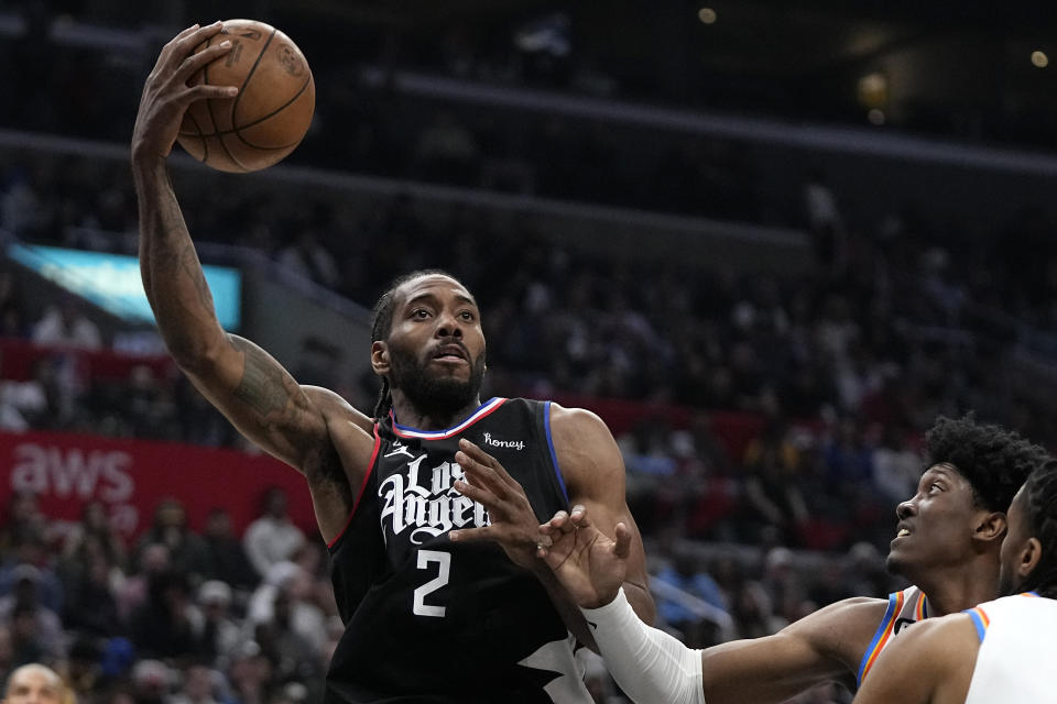 LA Clippers forward Kawhi Leonard, left, shoots as Oklahoma City Thunder forward Jalen Williams defends during the second half of an NBA basketball game Thursday, March 23, 2023, in Los Angeles. (AP Photo/Mark J. Terrill)