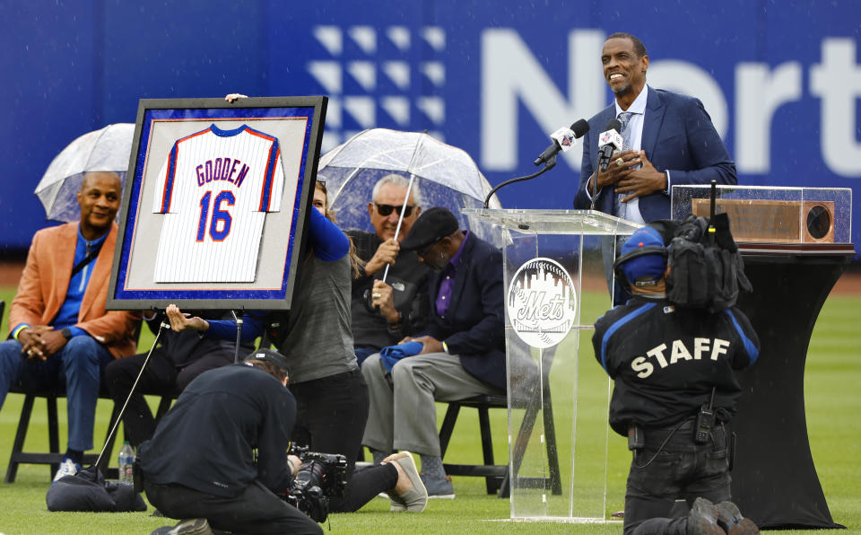 Former New York Mets pitcher Dwight Gooden, top right, acknowledges fans during a ceremony to retire his number at Citi Field before a baseball game between the Mets and the Kansas City Royals, Sunday, April 14, 2024, in New York. (AP Photo/Noah K. Murray)