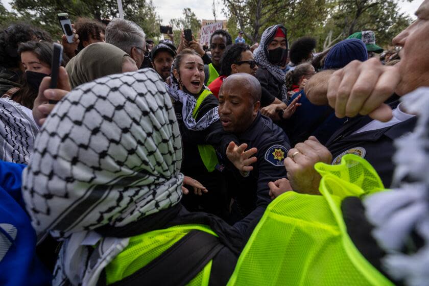 Los Angeles, CA - April 24: Public safety officers confront pro-Palestinian demonstrators at USC on Wednesday, April 24, 2024 in Los Angeles, CA. (Brian van der Brug / Los Angeles Times)