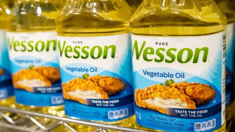 Three bottles of Wesson cooking oil.