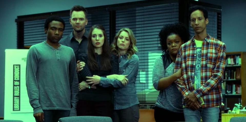 Troy, Jeff, Annie, Britta, Shirley, and Abed mourning over Pierce's death by staring at his study chair in "Community"