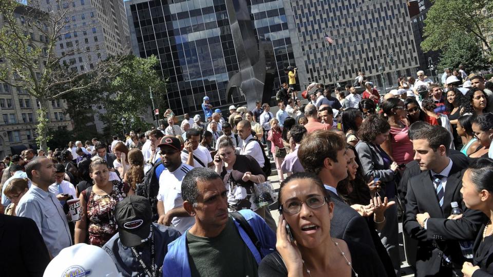 PHOTO: People stand in a square outside the courthouse after an earthquake was felt in New York City, Aug. 23, 2011. (Nicholas Kamm/AFP via Getty Images)