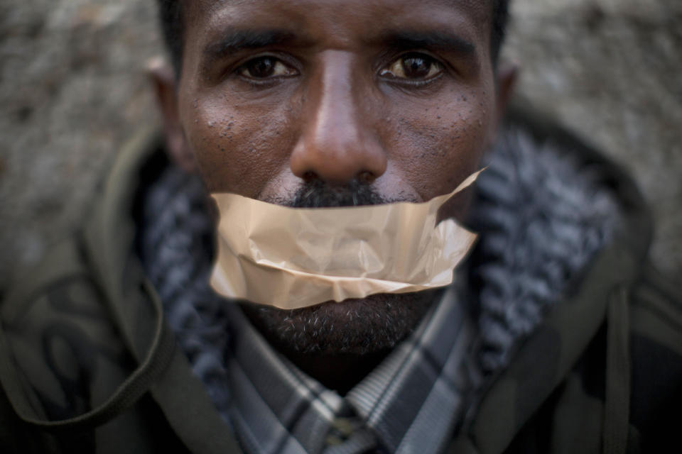 <p>An African migrant covers his mouth with tape during a protest in front of the U.S. Embassy, demanding asylum and work rights from the Israeli government in Tel Aviv, Israel, Jan. 22, 2014. (Photo: Oded Balilty/AP) </p>