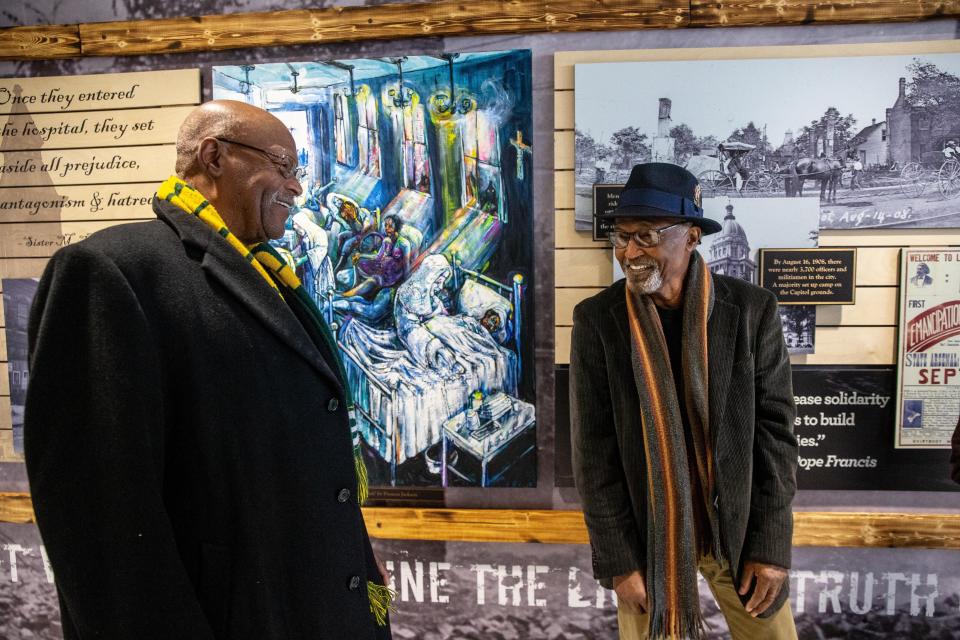 Peoria artist Preston Jackson, right, talks to the late Leroy Jordan about his mural commemorating the 1908 Springfield Race Riot. Jackson has another sculpture, commissioned by the Springfield Branch of the NAACP, sitting in Union Square Park.