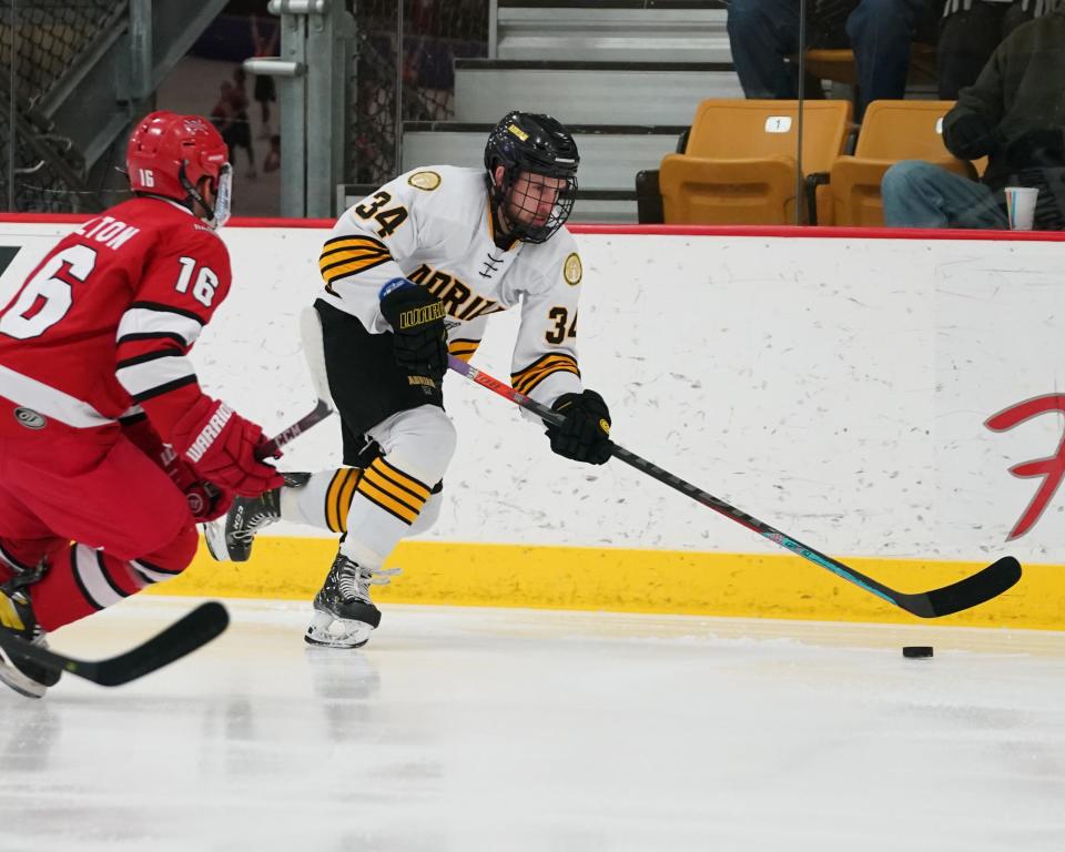 Adrian College's Trevor Coykendall (34) bring the puck up ice during Saturday's Northern Collegiate Hockey Association game against Milwaukee School of Engineering.