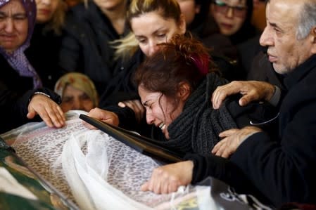 Asiye (L), mother of Destina Peri Parlak, one of the victims of Sunday's suicide bomb attack, mourns over her daughter's coffin during a funeral ceremony in Ankara, Turkey March 15, 2016. REUTERS/Umit Bektas TPX IMAGES OF THE DAY