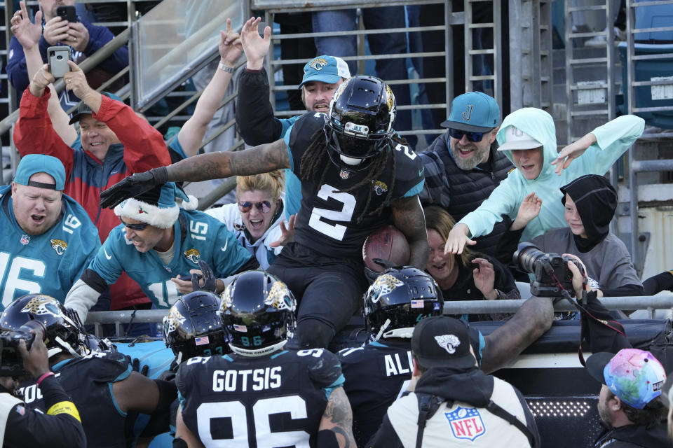Jacksonville Jaguars safety Rayshawn Jenkins (2) celebrates with fans after an interception during the second half of an NFL football game against the Dallas Cowboys, Sunday, Dec. 18, 2022, in Jacksonville, Fla. (AP Photo/John Raoux)
