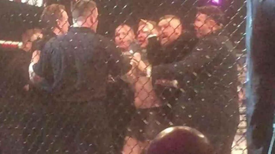 McGregor being held back after attacking referee