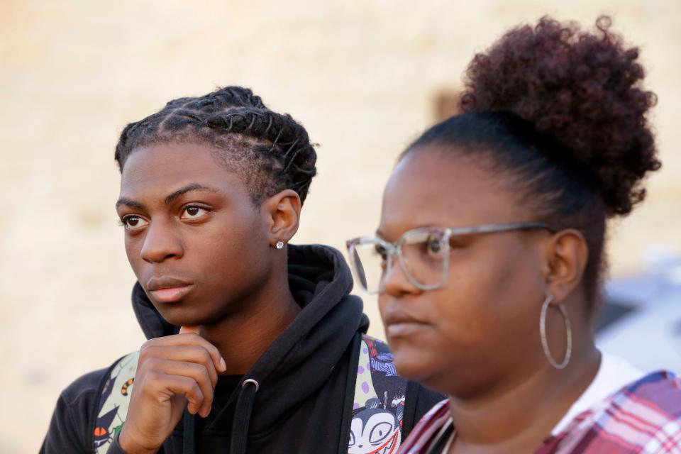 Darryl George, left, an 18 year-old junior, and his mother Darresha George, right, talk with reporters before walking into Barbers Hill High School after he served an in-school suspension for not cutting his hair on Sept. 18, 2023, in Mont Belvieu, Texas. (AP Photo/Michael Wyke)