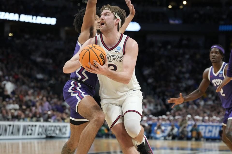 Gonzaga forward Drew Timme drives to the rim past TCU guard Micah Peavy.