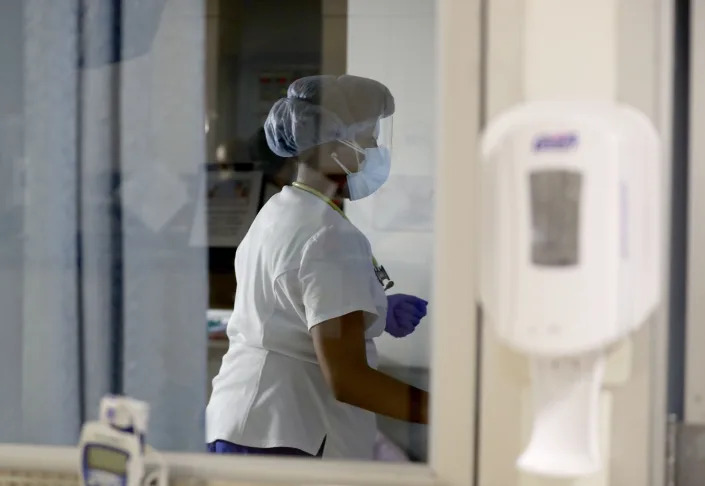 Vanessa Jean-Baptiste, a registered nurse in the intensive care unit at Northern Westchester Hospital in Mount Kisco, cares for a patient March 1, 2022. Two years into the COVID19 pandemic, Jean-Baptiste continues to work three 7:00 pm to 7:00 am shifts a week in the hospital's ICU.