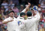 Australian team mates congratulate Josh Hazlewood (R) who participated in the running-out dismissal of West Indies batsman Marlon Samuels (not pictured) during their third cricket test at the SCG in Sydney, January 3, 2016. REUTERS/Jason Reed