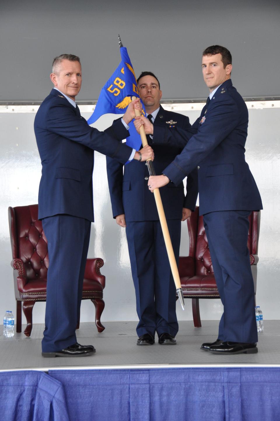 U.S. Air Force Col. Derek Price, commander of the 58th Operations Group, left, bestowes command of the 58th OG Detachment 3 to Lt. Col. Derek Cumbie, right, as is symbolized by the passing of the unit’s guidon during the unit’s activation ceremony Jan. 31, 2024, at Maxwell Air Force Base, Alabama. Det. 3 is the active associate unit to the 908th Airlift Wing for their new mission as the formal training unit for the MH-139A Grey Wolf helicopter.