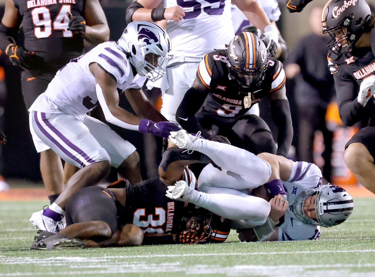 Kansas State quarterback Will Howard (18) falls on the ball after a bad snap during the Wildcats' game against Oklahoma State on Friday night at Boone Pickens Stadium.