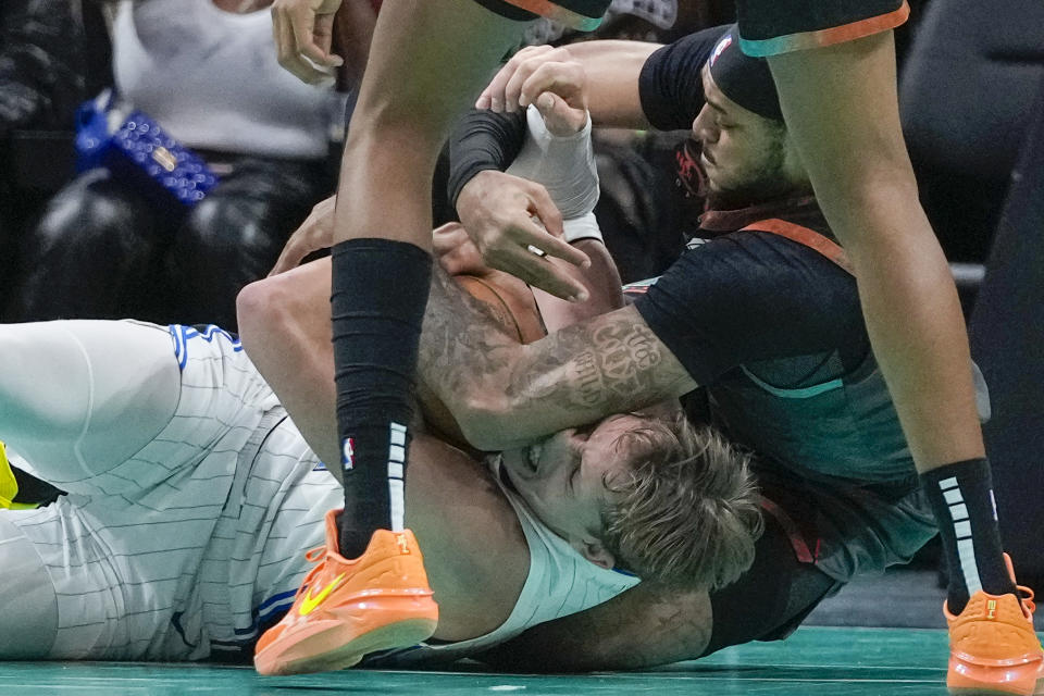 Orlando Magic center Moritz Wagner, bottom left, hangs onto the loose ball with Washington Wizards center Daniel Gafford on top of him, during the second half of an NBA basketball game, Tuesday, Dec. 26, 2023, in Washington. (AP Photo/Alex Brandon)