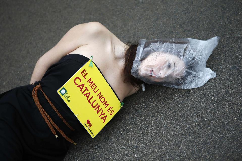 A pro-independence supporter for Catalonia stages a protest in front of the regional parliament during a vote to petition the central government to allow a referendum