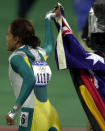 <p>Freeman carries the Australian and Aboriginal flags on a lap of honour.</p>