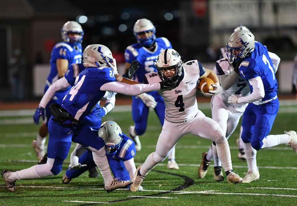 Rochester's Antonio Laure picks up some yards against Union during a class 1A WPIAL playoff game Friday night at Freedom Area High School.