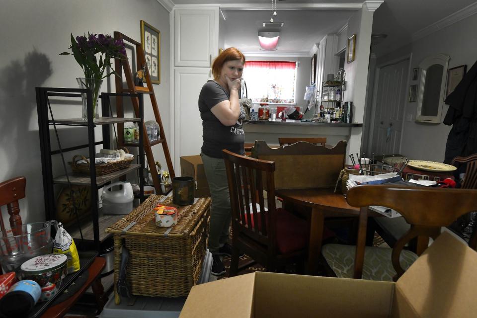 Rebecca Shore tries to decide where to start as she boxes up belongings in her Jacksonville apartment to move to Kentucky. Shore's rent was increased by $300 a month, forcing her to rethink where to live.
