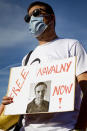 A protester holds a sign during a peaceful rally to speak up against political repressions, human rights violations and antidemocratic rule in Russia, during a demonstration in Geneva, Switzerland, Tuesday, June 15, 2021. Geneva is hosting a meeting between U.S. President Biden and Russian President Putin on June 16. A couple dozen supporters of Navalny, the jailed Russian opposition leader, staged a rally Tuesday on a sun-drenched Geneva square.(Magali Girardin/Keystone via AP)